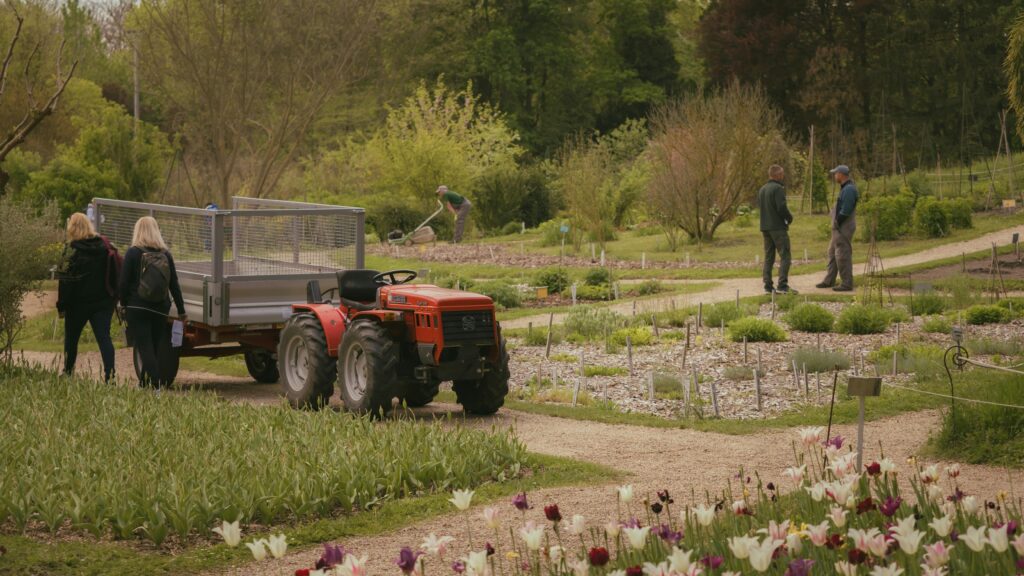 A scenic view of a tractor in a vibrant spring garden in Vácrátót, Hungary.